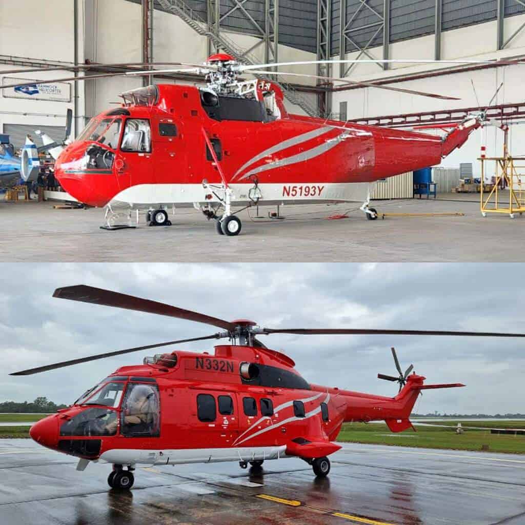 Two red and white helicopters are parked, one inside a hangar and one outside on a wet runway.